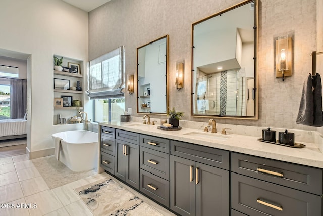 bathroom featuring vanity, tile patterned flooring, a wealth of natural light, and independent shower and bath