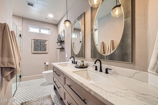 bathroom featuring vanity, tile patterned flooring, and toilet