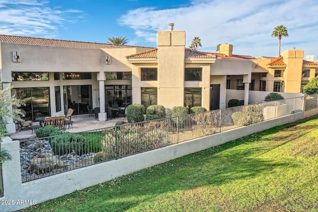 rear view of property with a patio area and a lawn