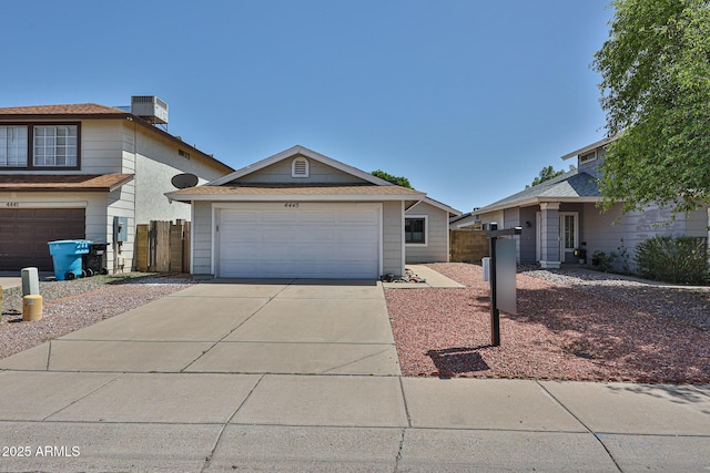 4445 W Oraibi Dr, Glendale, AZ 85308 - view of front of home with a garage, fence, concrete driveway, and a chimney