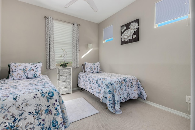 bedroom with baseboards, carpet, and a ceiling fan