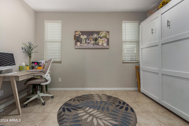 office space with light tile patterned floors and baseboards