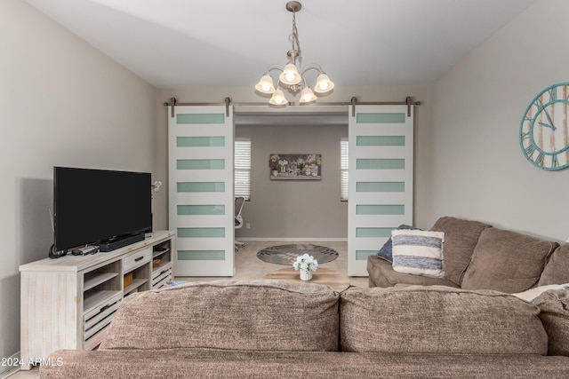 living room with tile patterned floors, a barn door, baseboards, and an inviting chandelier