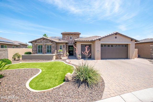 16772 W Cypress St, Goodyear, AZ 85395 - mediterranean / spanish home with an attached garage, a tile roof, stucco siding, roof mounted solar panels, and driveway