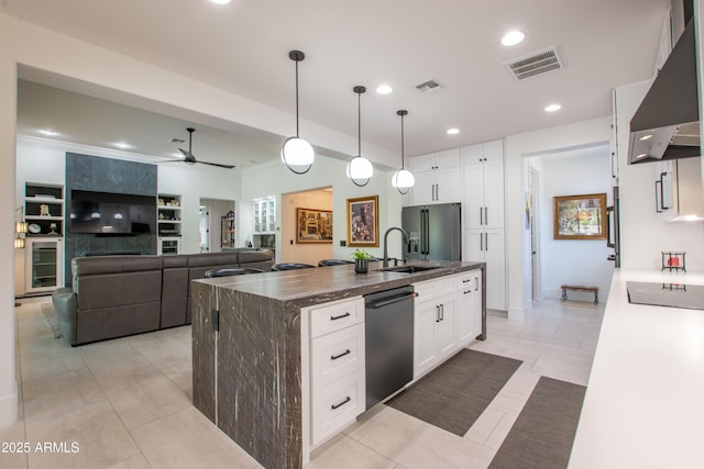 16772 W Cypress St, Goodyear, AZ 85395 - kitchen featuring stainless steel appliances, wall chimney exhaust hood, dark countertops, a sink, and ceiling fan