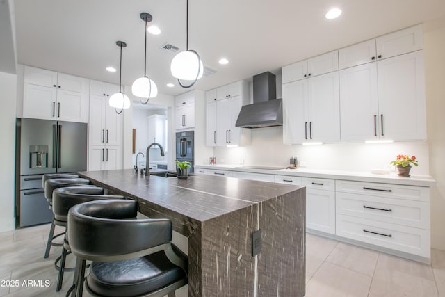 16772 W Cypress St, Goodyear, AZ 85395 - kitchen featuring wall chimney range hood, black appliances, a sink, a center island with sink, and white cabinets