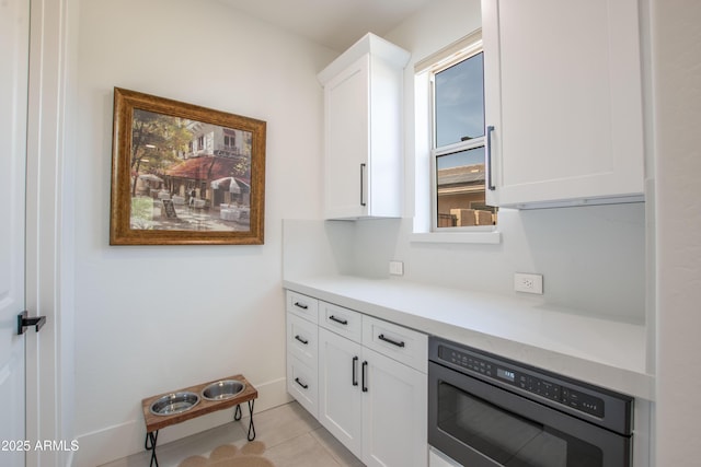 16772 W Cypress St, Goodyear, AZ 85395 - kitchen featuring wall oven, white cabinetry, light countertops, and light tile patterned flooring