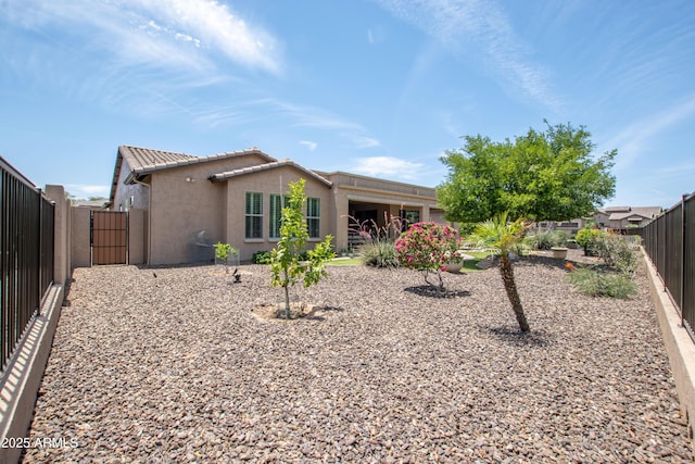 16772 W Cypress St, Goodyear, AZ 85395 - rear view of house with stucco siding, a fenced backyard, and a tiled roof