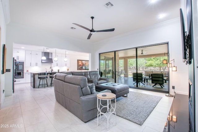 16772 W Cypress St, Goodyear, AZ 85395 - living room featuring a ceiling fan, ornamental molding, and light tile patterned floors