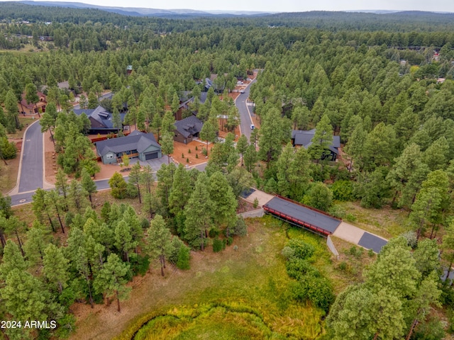 birds eye view of property with a view of trees