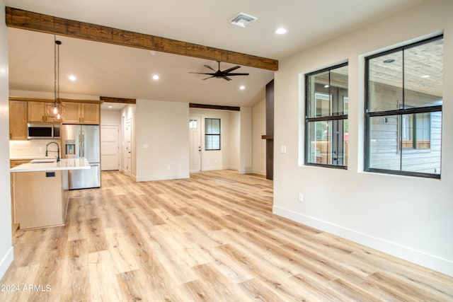 kitchen with open floor plan, light countertops, appliances with stainless steel finishes, and visible vents