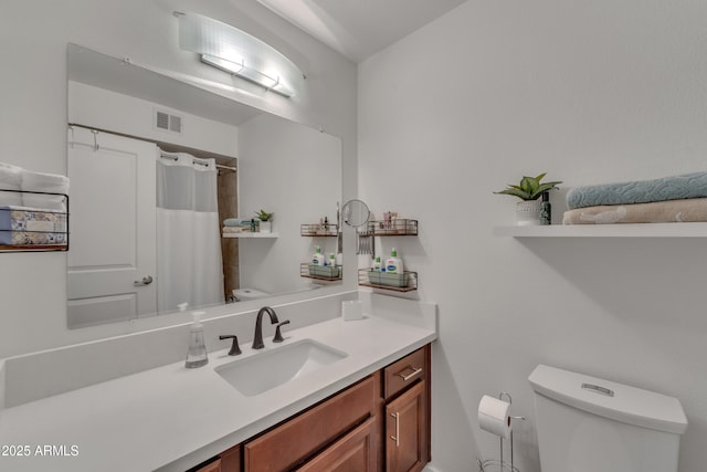 bathroom featuring toilet, visible vents, curtained shower, and vanity