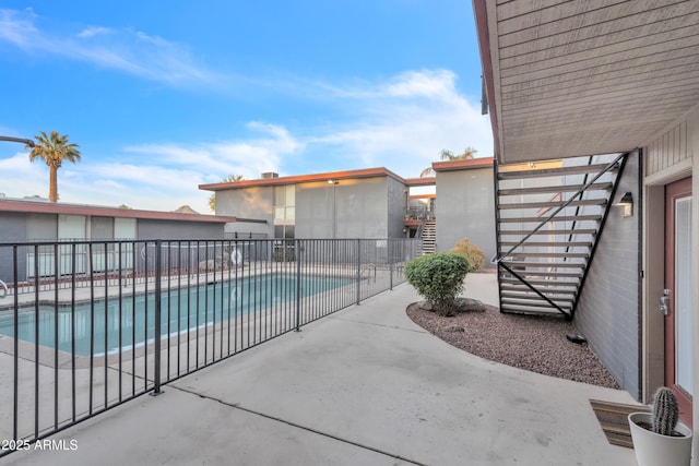 community pool featuring a patio and fence
