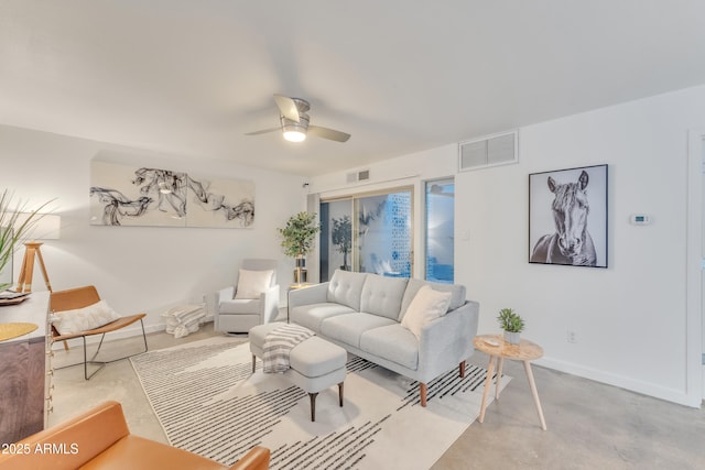 living area featuring baseboards, ceiling fan, concrete flooring, and visible vents