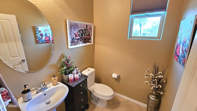 bathroom featuring tile patterned flooring, toilet, and sink