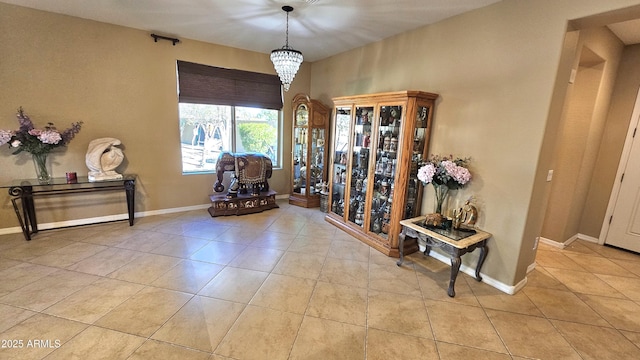 living area with light tile patterned floors and an inviting chandelier