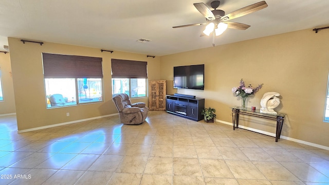 sitting room with ceiling fan and light tile patterned floors