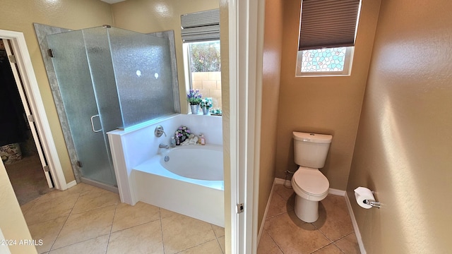 bathroom with tile patterned flooring, plenty of natural light, and toilet