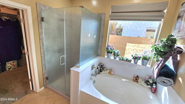 bathroom featuring tile patterned floors and separate shower and tub