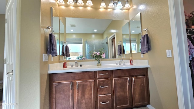 bathroom featuring vanity and a shower with shower door