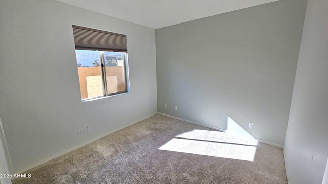 spare room featuring light colored carpet