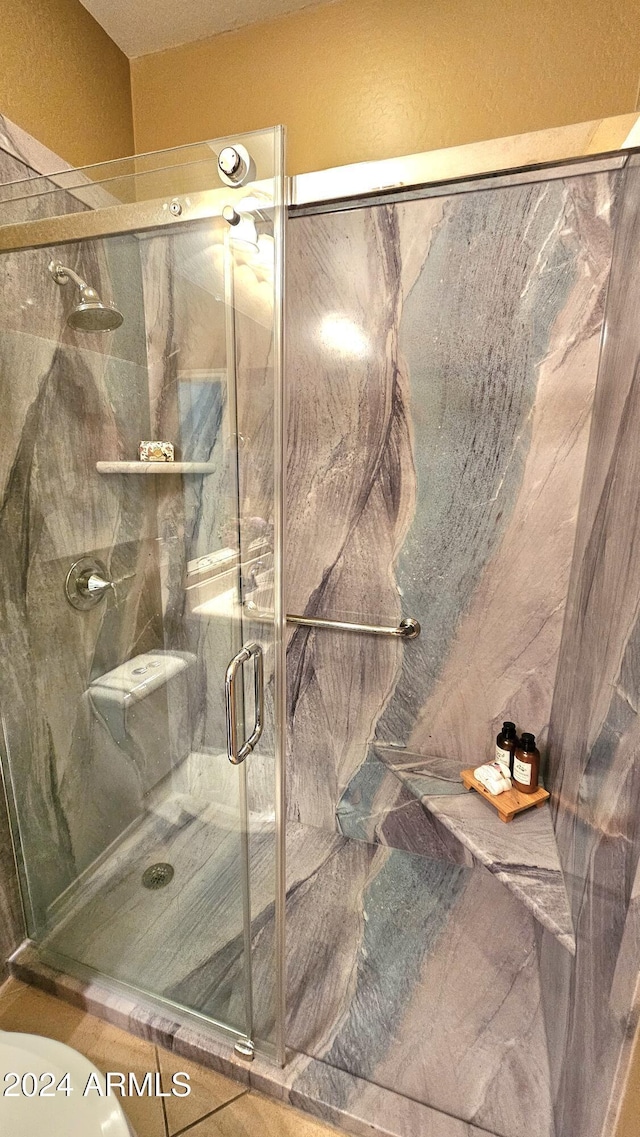 bathroom with a shower with door