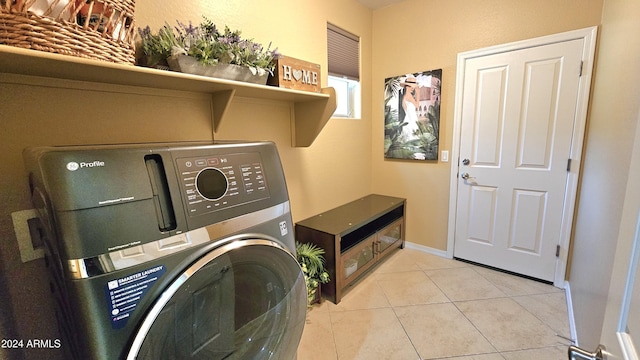 laundry area with washer / dryer and light tile patterned floors