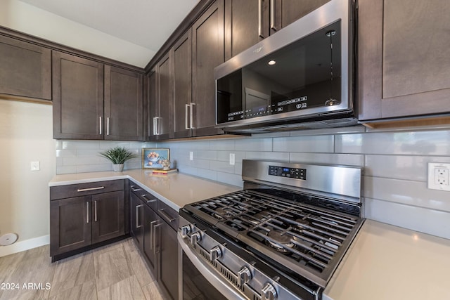 kitchen featuring backsplash, dark brown cabinetry, and stainless steel appliances