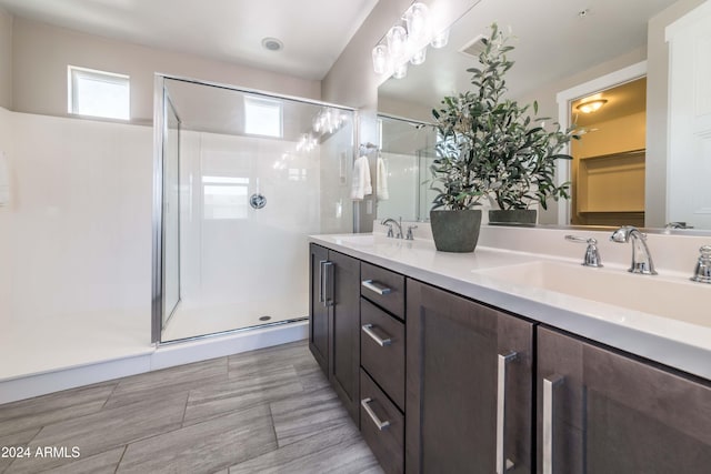 bathroom featuring vanity and an enclosed shower