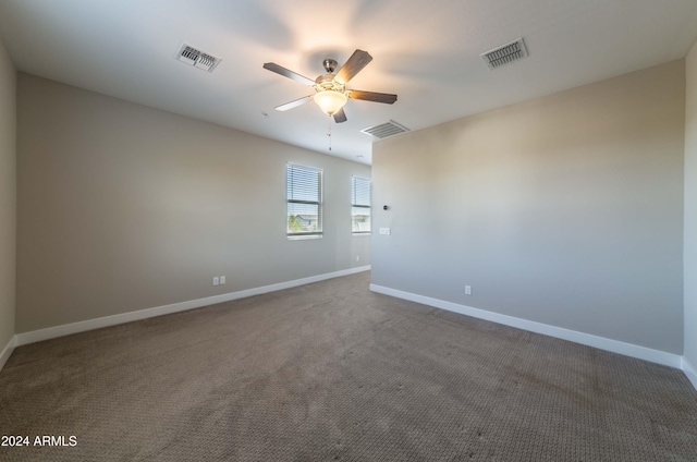 carpeted spare room with ceiling fan