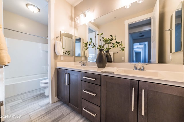 full bathroom featuring vanity, bathtub / shower combination, and toilet