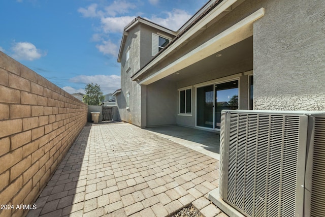 view of side of property featuring a patio area and central AC