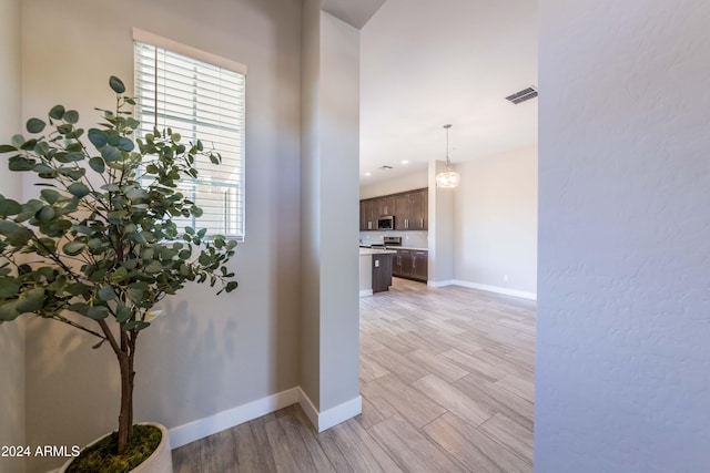 hall with light hardwood / wood-style flooring