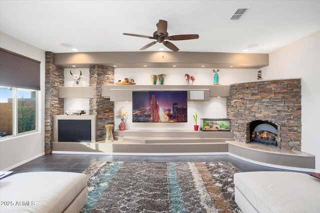 living room with a fireplace and ceiling fan