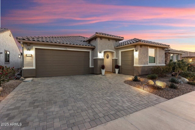 mediterranean / spanish-style home with a garage