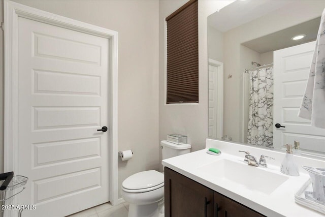 bathroom with tile patterned floors, curtained shower, vanity, and toilet