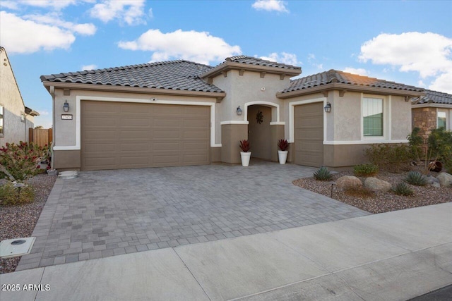 mediterranean / spanish-style house with a garage