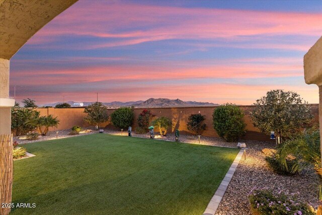 yard at dusk featuring a mountain view