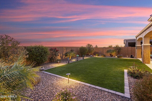 view of yard at dusk