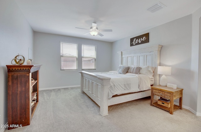bedroom with baseboards, visible vents, ceiling fan, and light colored carpet
