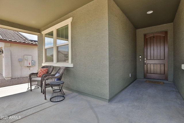 property entrance featuring stucco siding