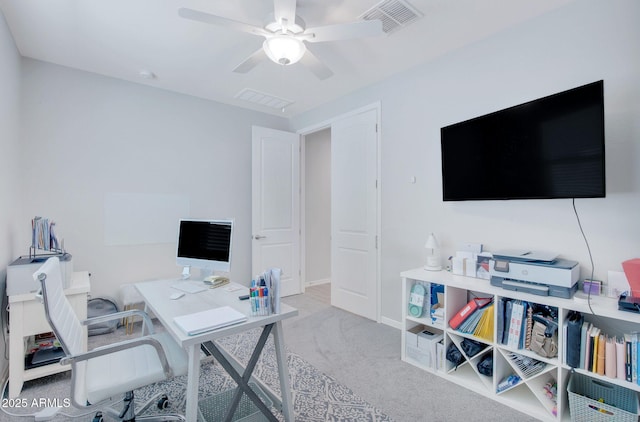 office area with visible vents, ceiling fan, carpet floors, and baseboards