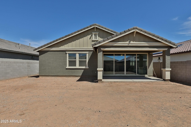 rear view of property with a patio, a fenced backyard, and a tiled roof