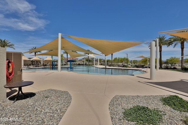 pool featuring fence and a patio area