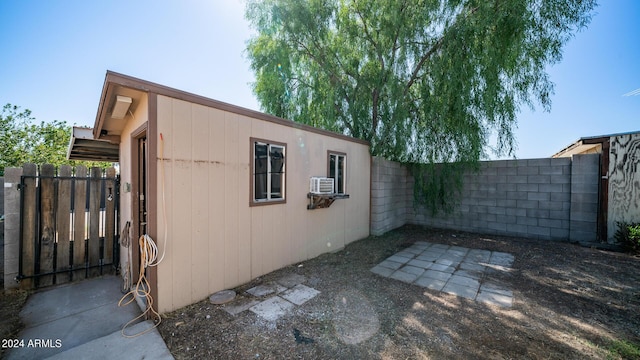 view of home's exterior with cooling unit, a fenced backyard, and a patio