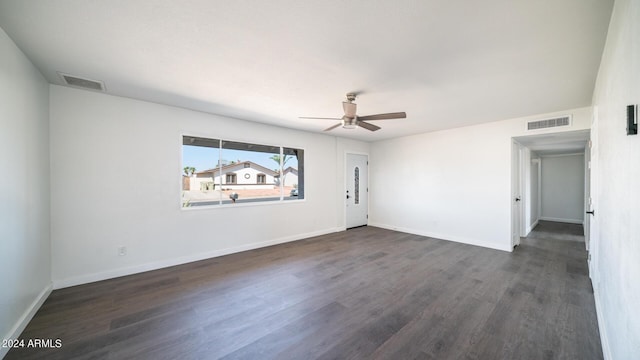 empty room featuring baseboards, visible vents, and wood finished floors