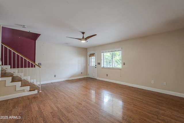 533 N Cobblestone St, Gilbert, AZ 85234 - unfurnished living room with wood finished floors, a ceiling fan, baseboards, and stairway