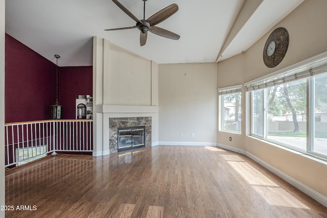 533 N Cobblestone St, Gilbert, AZ 85234 - unfurnished living room featuring ceiling fan, wood finished floors, healthy amount of natural light, baseboards, and high vaulted ceiling