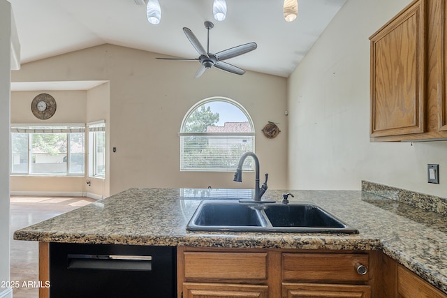 533 N Cobblestone St, Gilbert, AZ 85234 - kitchen featuring a sink, lofted ceiling, brown cabinetry, ceiling fan, and a peninsula