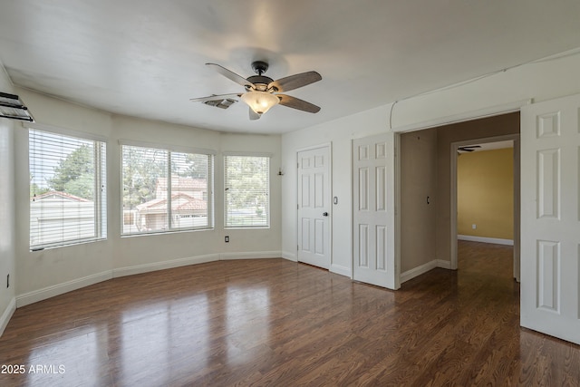 533 N Cobblestone St, Gilbert, AZ 85234 - unfurnished bedroom with dark wood-type flooring, baseboards, a ceiling fan, and a closet
